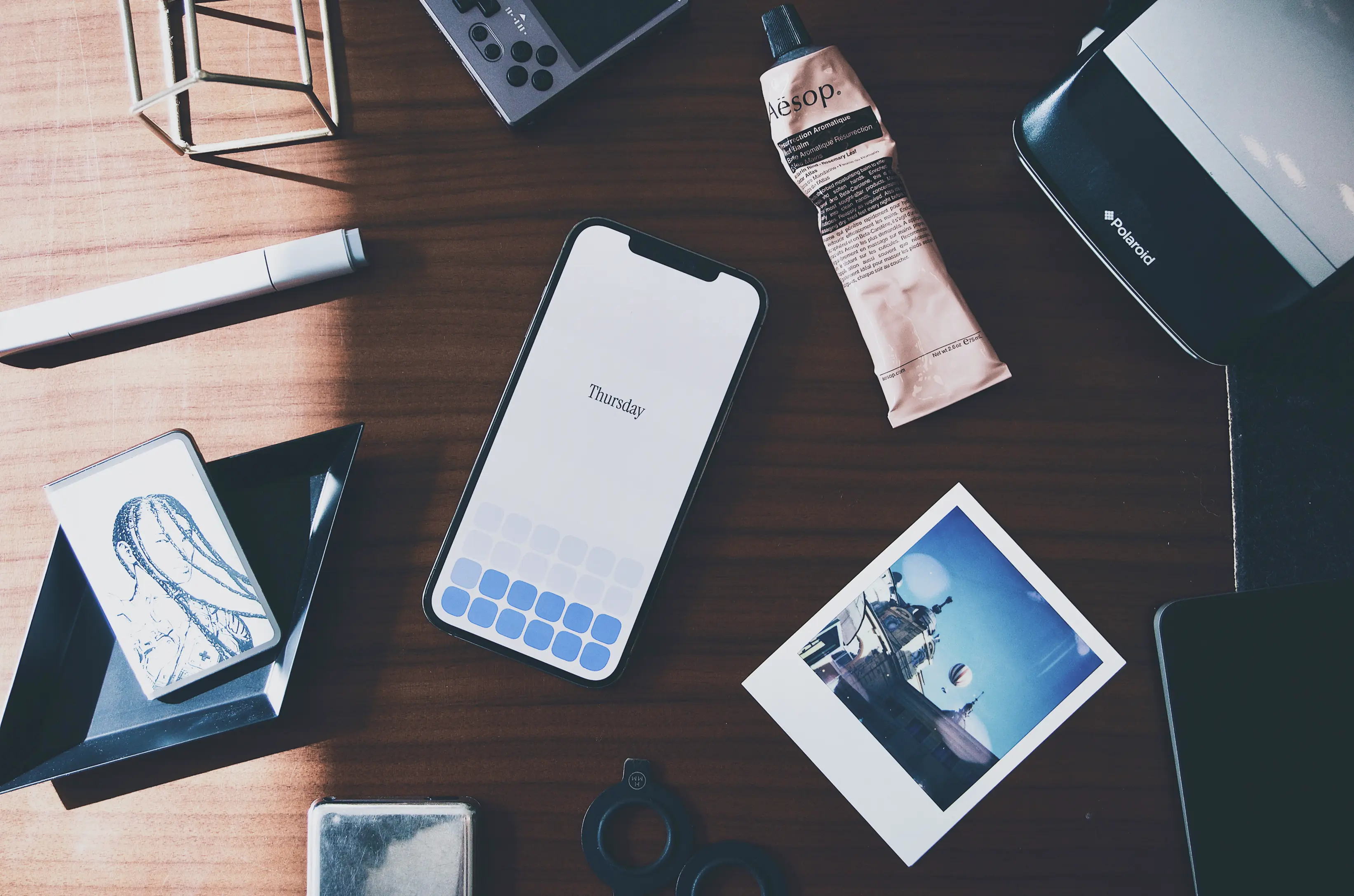 Spent on iPhone, on a wooden desk with everyday objects