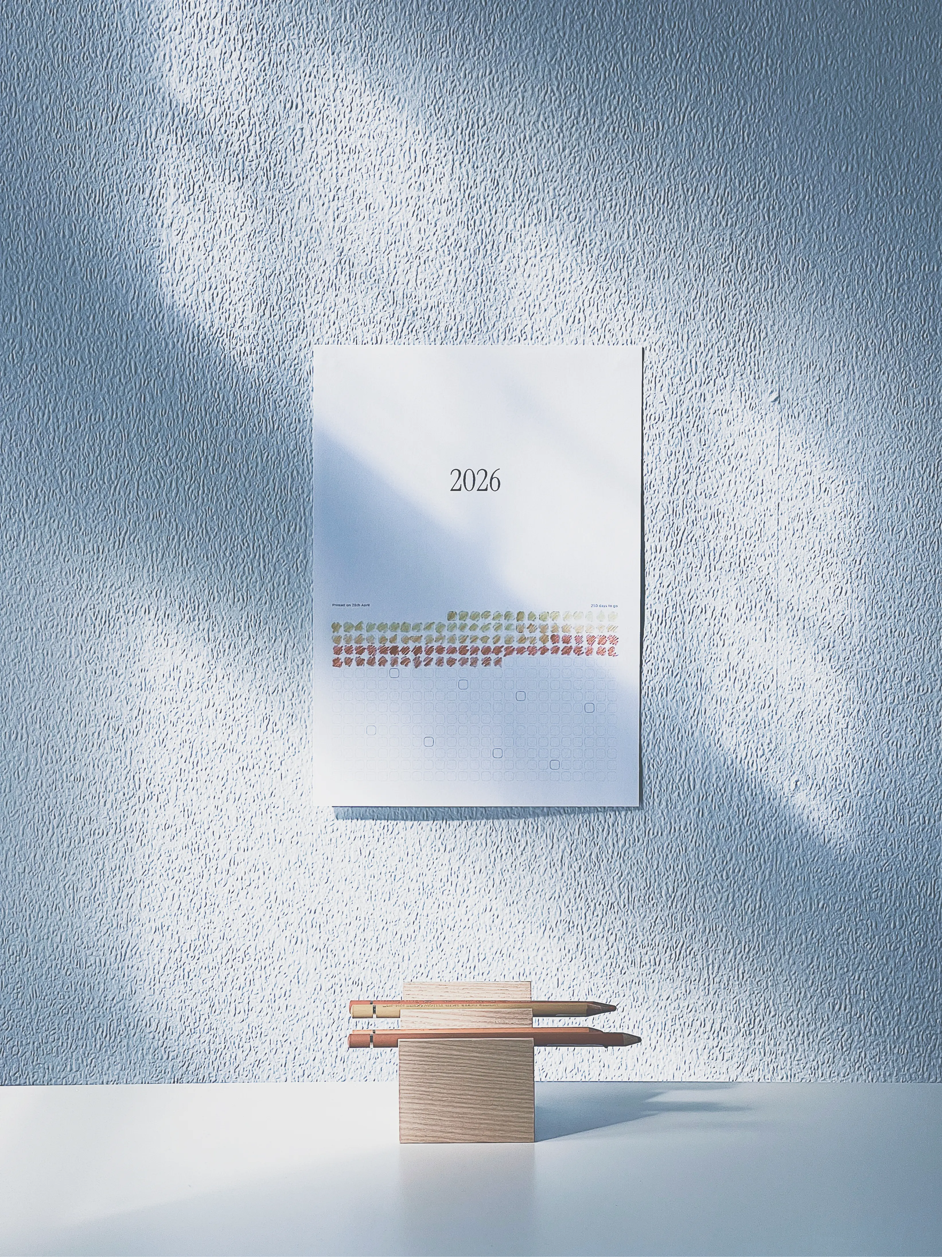 A printed year calendar pinned to a white wall